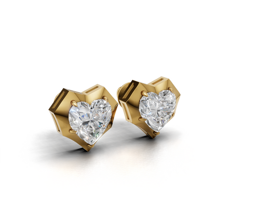 Heart diamond yellow gold stud earrings with prong setting, angled three-quarter view